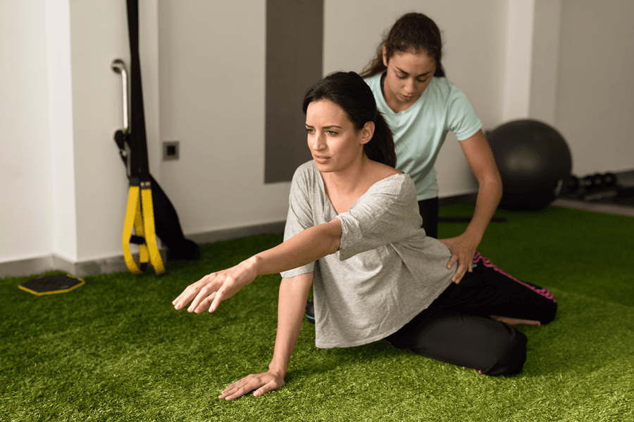 physical therapist assisting young