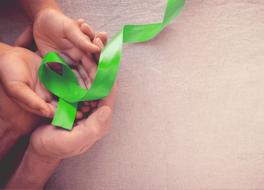 Hands holding Green Ribbon