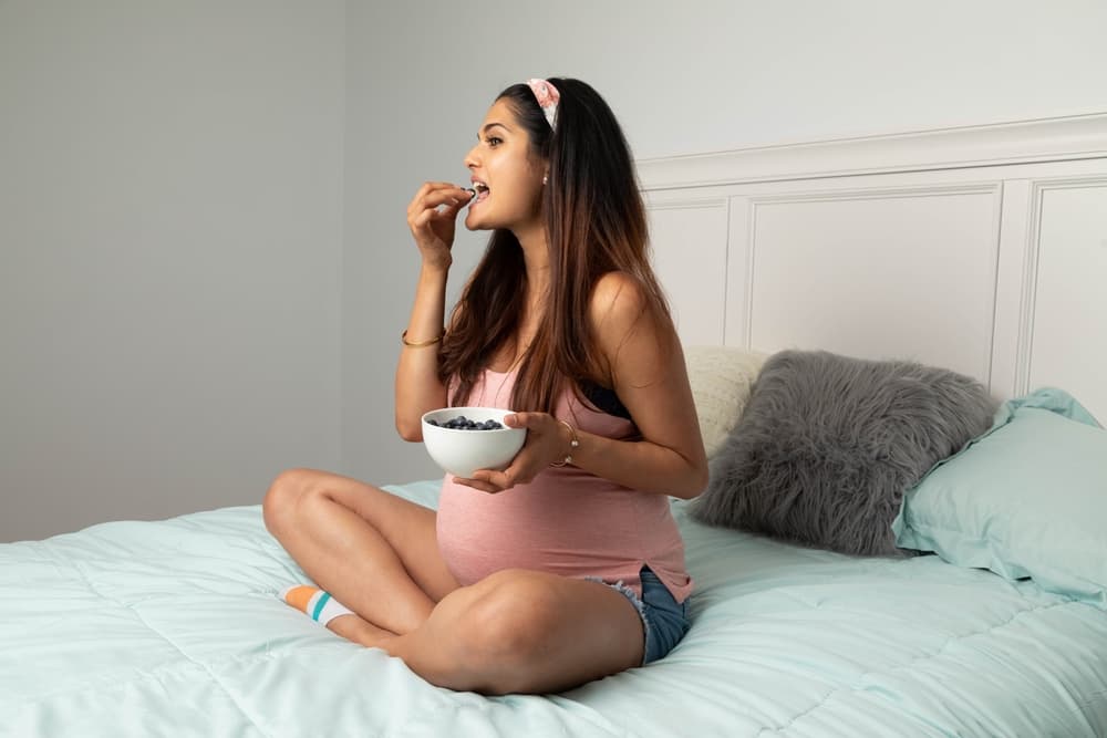 Pregnant woman eating snacks