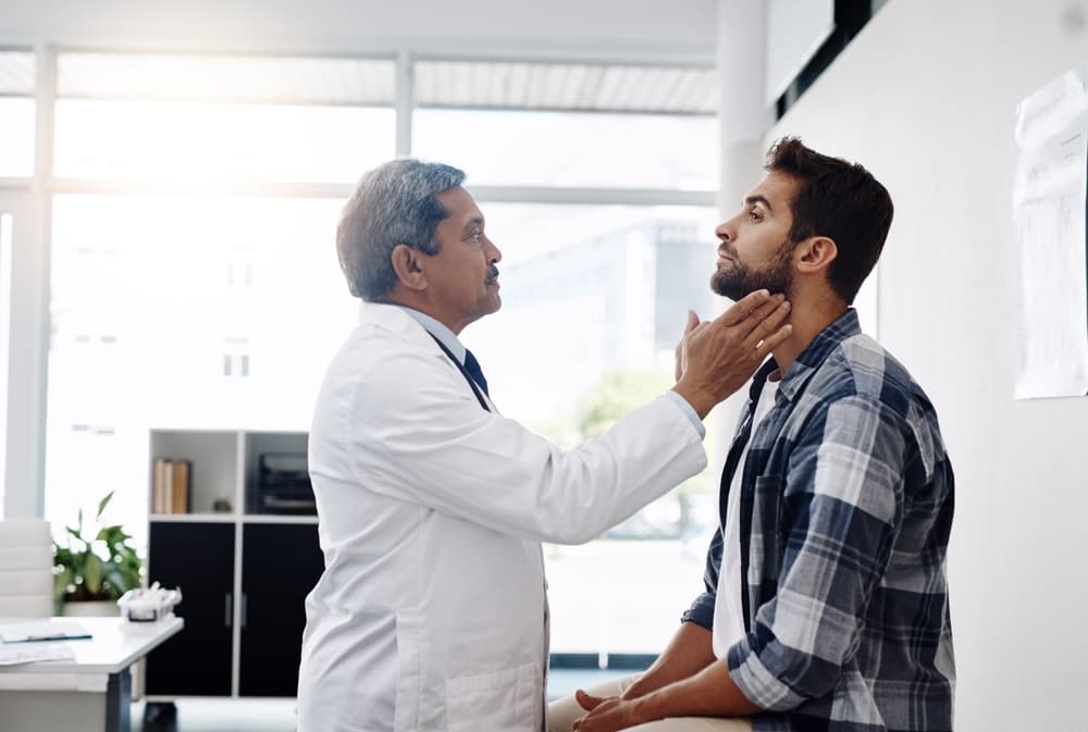 doctor checking patient with neck issues