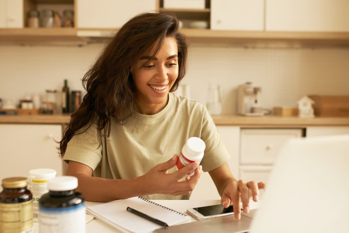 Happy woman holding tablet box
